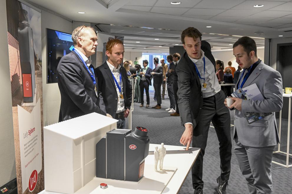 four people at a conference exhibition stand