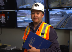 Nicholas Gutierrez at work wearing a hardhat and reflective safety vest