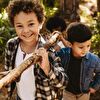 Boys Carrying Branch Together