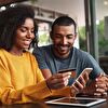 Couple at Home Purchasing With a Bank Card at Desk