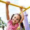 Girl in Pink Hanging by Hand From Climber