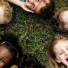 Kids Lying in Grass Heads Near