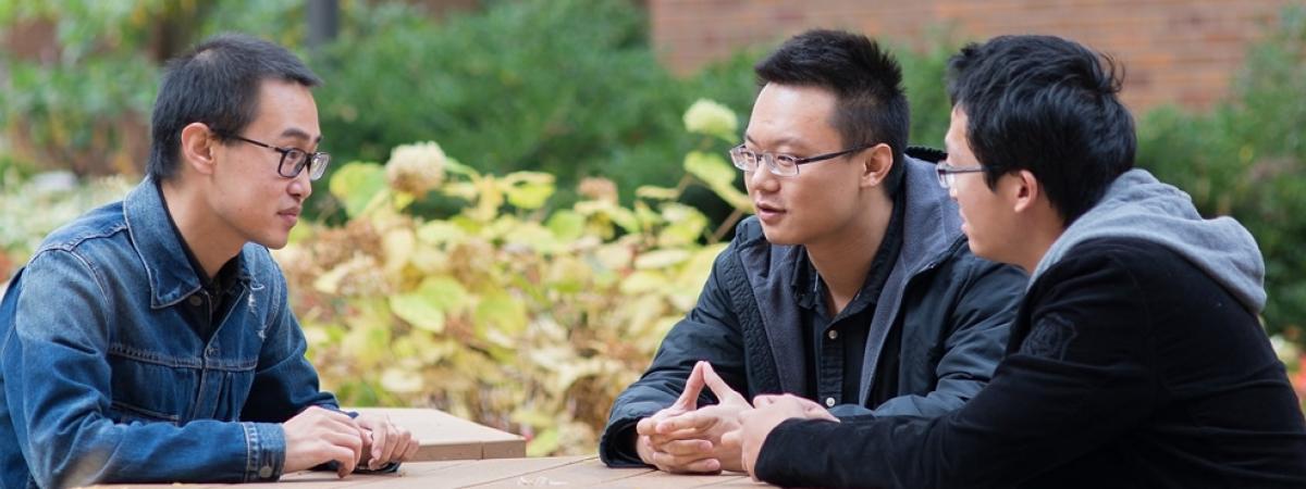 three law students sitting outside talking