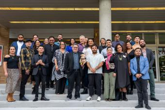 A large group photo on the steps of Bass Concert Hall