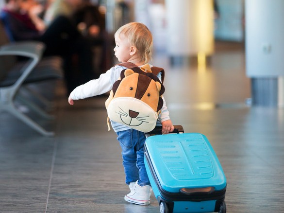 kid pulling suitcase