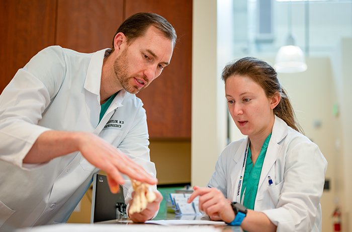 Dr. Kreule working with a resident