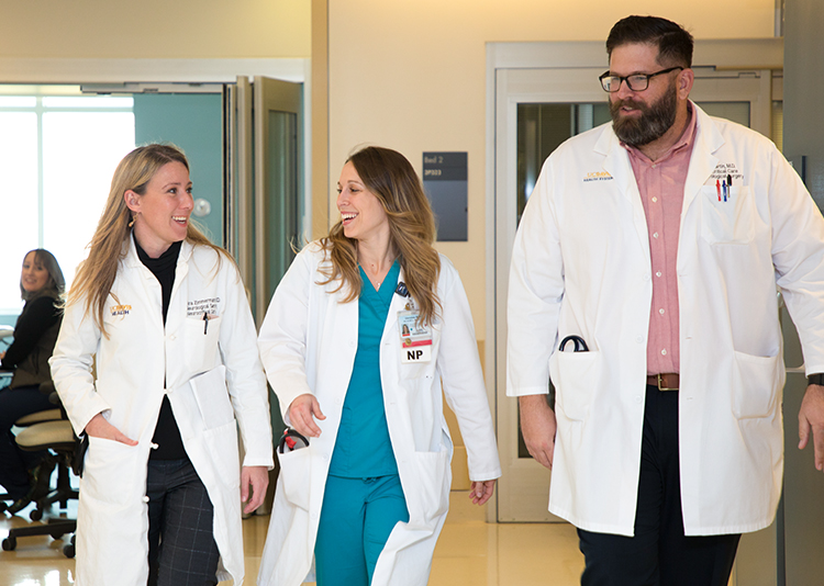 UC Davis Health health care providers walking inside the hospital.