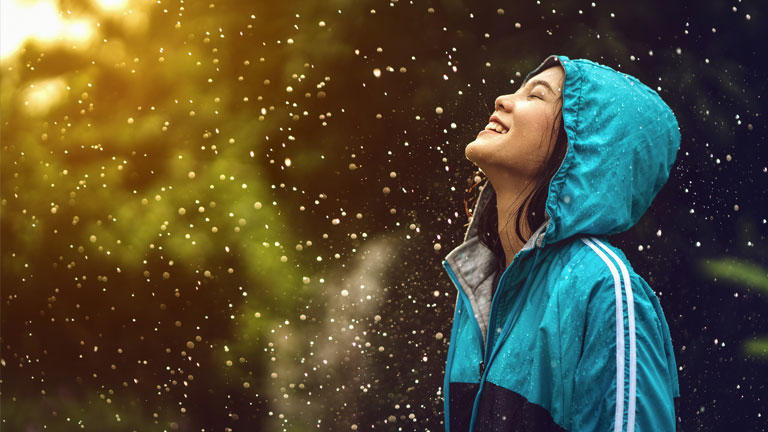 A girl finds joy in a rainstorm