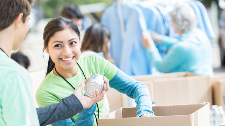 A girl volunteers at a food bank