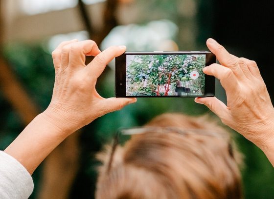 a person holding up a cellphone taking a picture