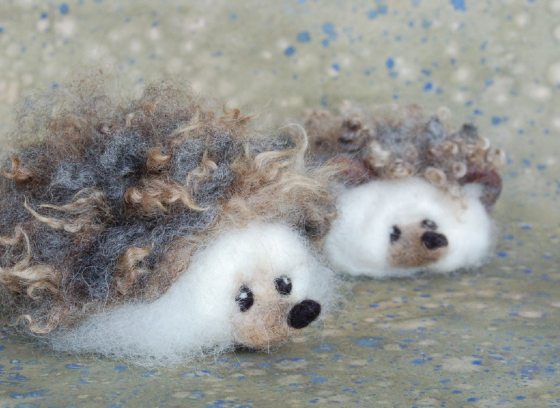 Two cutesy felt made hedgehogs.