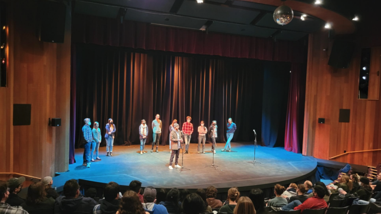 A view of a stage with several people standing on it