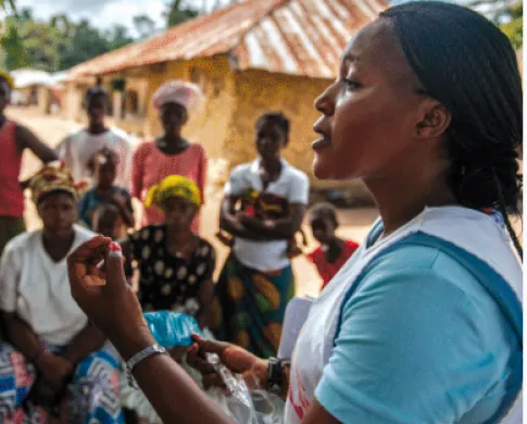 a woman speaking to a group of people 