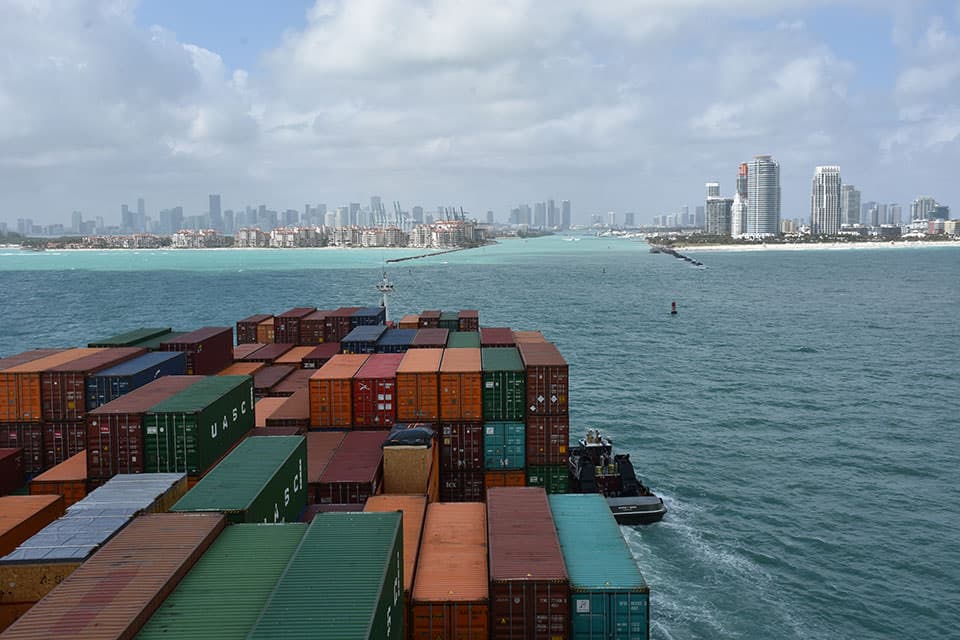 a ship coming into port loaded with containers