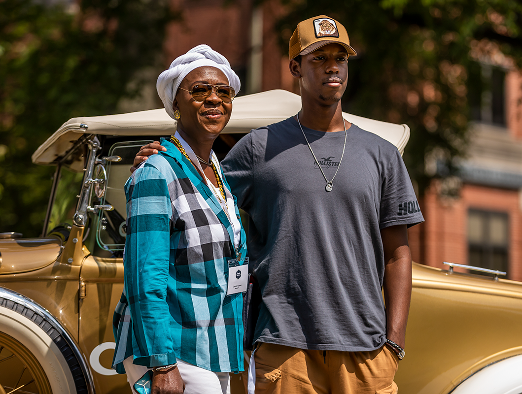 A proud Black mom with her Tech son student.