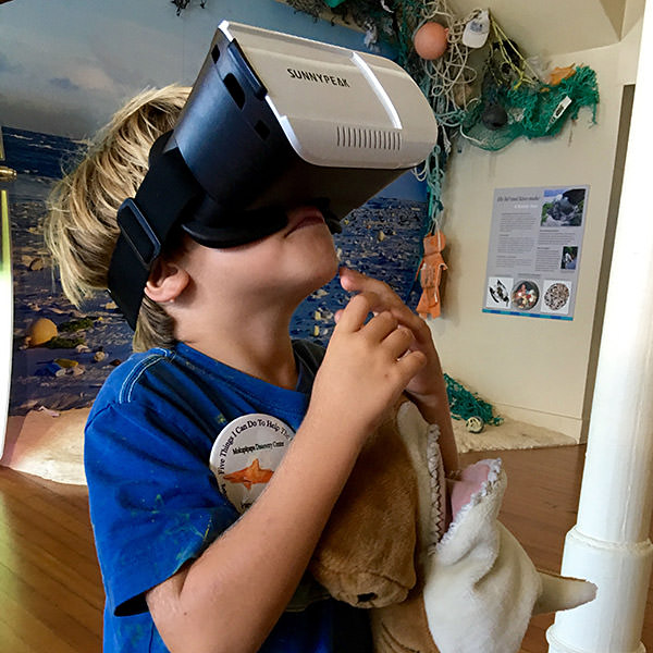 boy wearing vr goggles