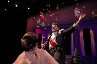 man throwing red confetti into the air