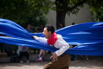 man with mask his body wrapped in blue drape