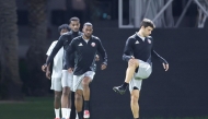 Lucas Mendes (right) and teammates attend Qatar's training session held in Doha just hours before team's departure to Abu Dhabi yesterday. 