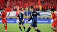 Japan's Ayumu Seko (2R) controls the ball during the 2026 FIFA World Cup qualification football match between China and Japan in Xiamen, in southeastern China's Fujian province on November 19, 2024. (Photo by STRINGER / AFP)