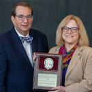 ruce H. Cohen, Child Neurology Society President, left, and Amy Brooks-Kayal, as she received the Bernard Sachs Award earlier this month.