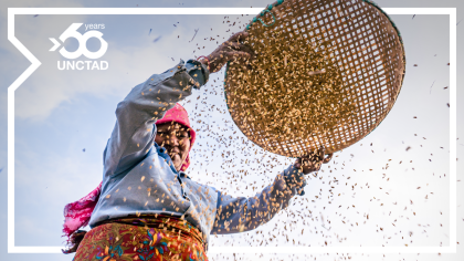 A woman sifts grain