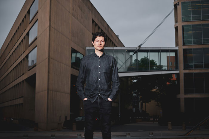 David Kasnter stands at Ames street with Building 66 in background