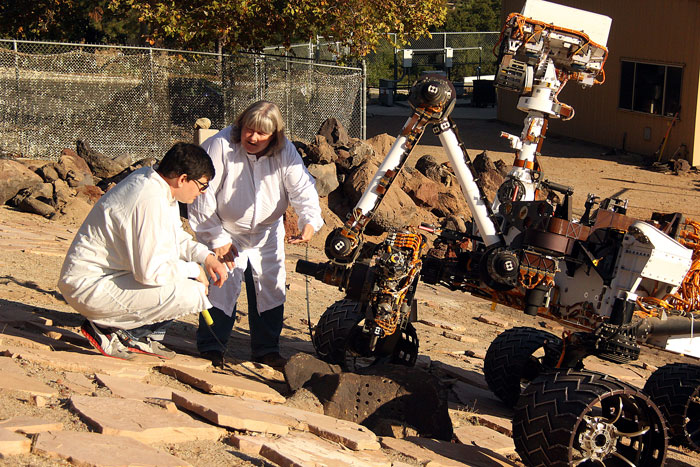 Louise Jandura speaks to a coworker while outside testing a lunar rover