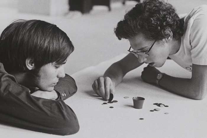 two students playing tiddlywinks