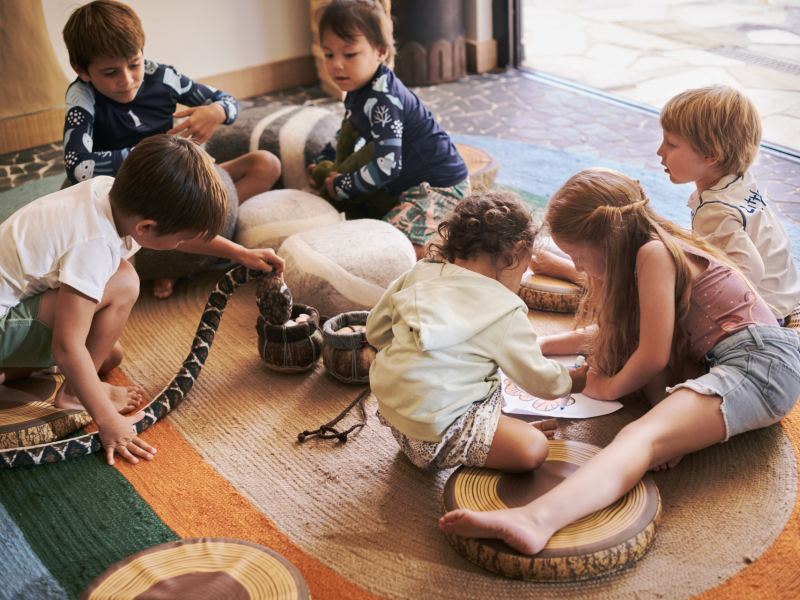 Children gathering on a floor rug