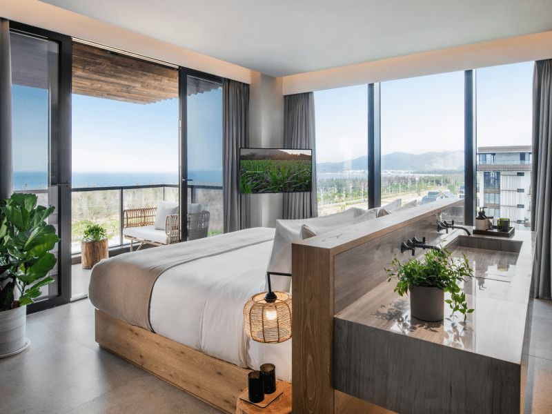 A bed with double sinks opposite the headboard