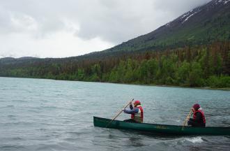 camp staff in canoe