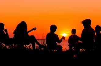 Silhouettes of group of people at sunset