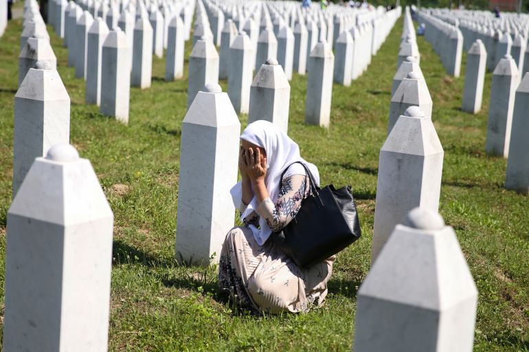 A woman cries at a graveyard, ahead of a mass funeral in Potocari near Srebrenica, Bosnia and Herzegovina July 11, 2020. Bosnia marks the 25th anniversary of the massacre of more than 8,000 Bosnian Muslim men and boys, with many relatives unable to attend due to the coronavirus disease (COVID-19) outbreak. REUTERS/Dado Ruvic