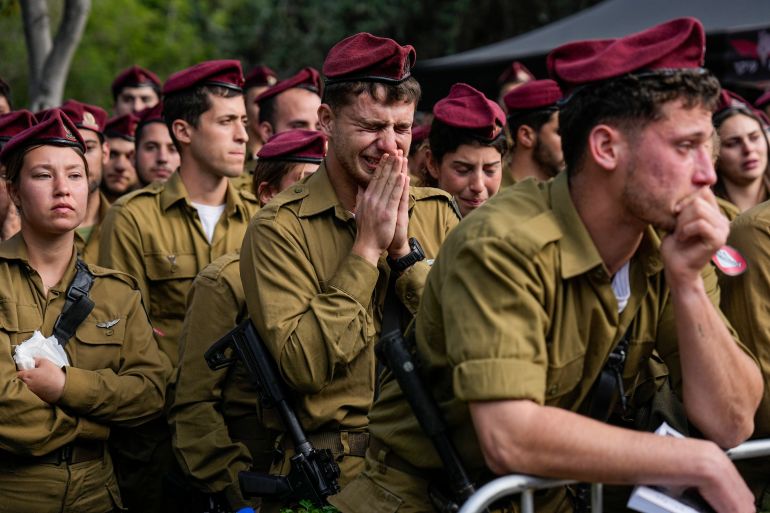 Israeli soldiers mourners in grief during the funeral of Israeli solider Staff sergeant David Sasson, in Netanya, Israel, Thursday, March 7, 2024. Sasson, 21, was killed during Israel's ground operation in the Gaza Strip, where the Israeli army has been battling Palestinian militants in the war ignited by Hamas' Oct. 7 attack into Israel. (AP Photo/Ariel Schalit)