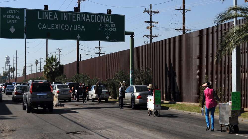 The metal fence runs along the length of the US-Mexico border into the desert [Joe Jackson /Al Jazeera] 