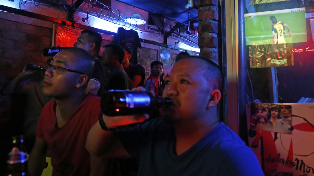 Vietnamese men watch a La Liga game in a bar in downtown Hanoi [Na Son Nguyen/Al Jazeera] 