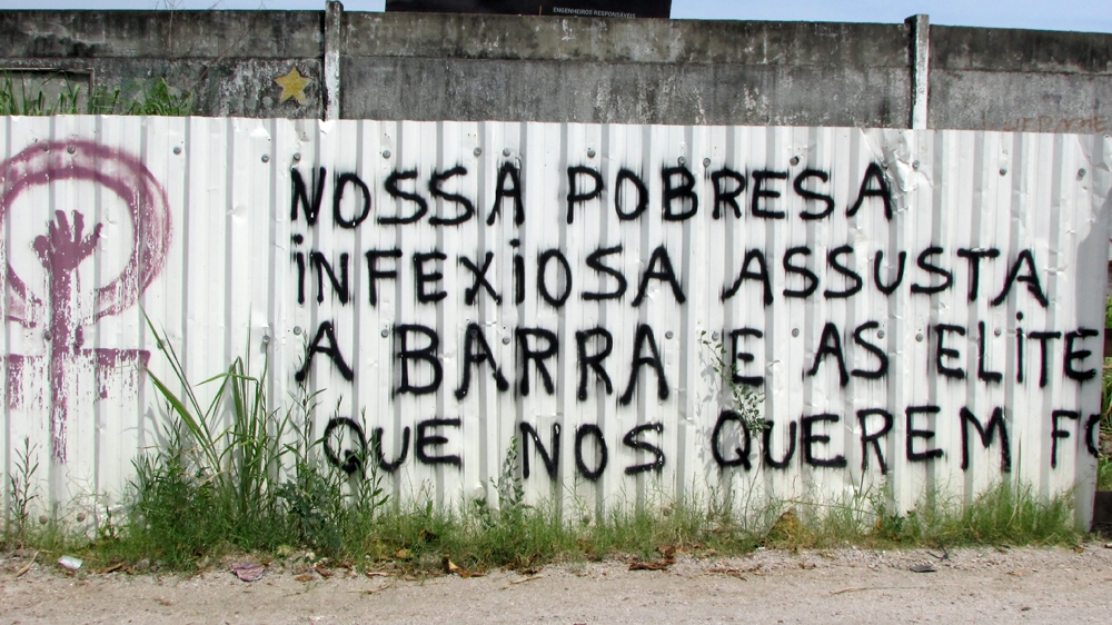 'Our infectious poverty scares the neighbourhood and the elites who want us out,' the message reads [Maya Thomas-Davis/Al Jazeera]