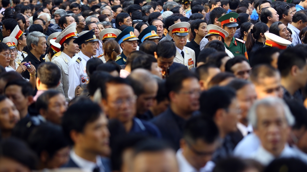 Vietnamese veterans and mourners form a long queue at the national funeral house for the funeral procession of the late General Vo Nguyen Giap [Na Son Nguyen/Al Jazeera] 