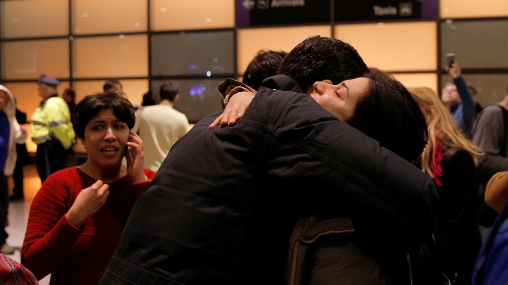 An Iranian professor who has a green card is reunited with friends and family after being questioned at Boston's Logan Airport [Reuters]