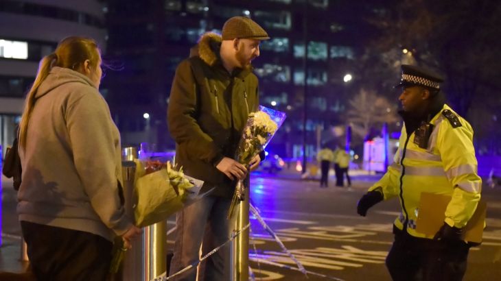 People leave flowers at the scene after an attack on Westminster Bridge in London