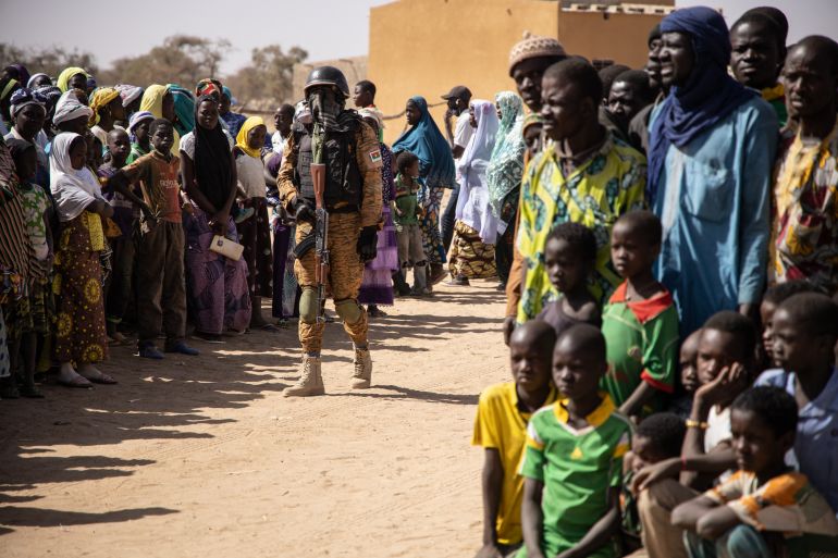 A Burkina Faso soldier welcomes internally displaced people