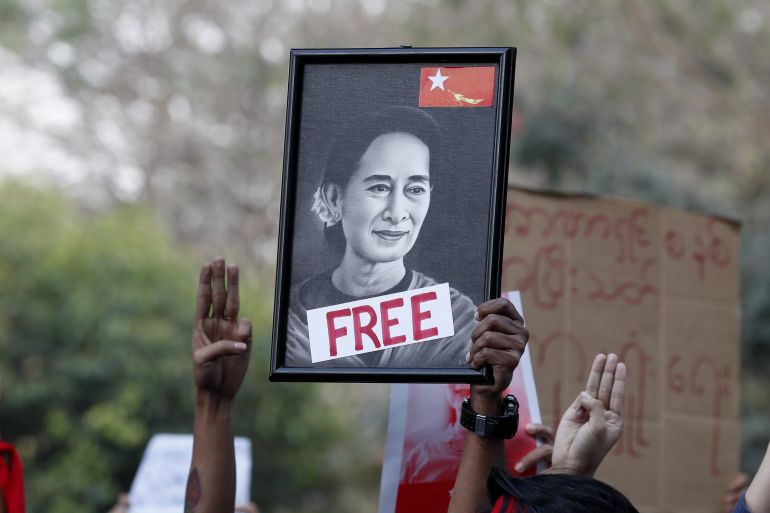 Demonstrators hold a portrait of detained State Counselor Aung San Suu Kyi