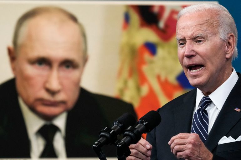 An image of Russian President Vladimir Putin is displayed as U.S. President Joe Biden speaks about gas prices.