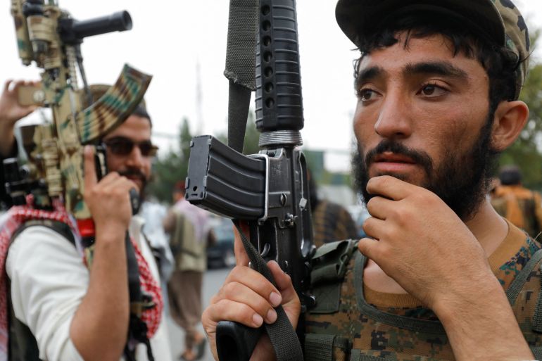 Taliban fighters stand as they celebrate the first anniversary of the fall of Kabul