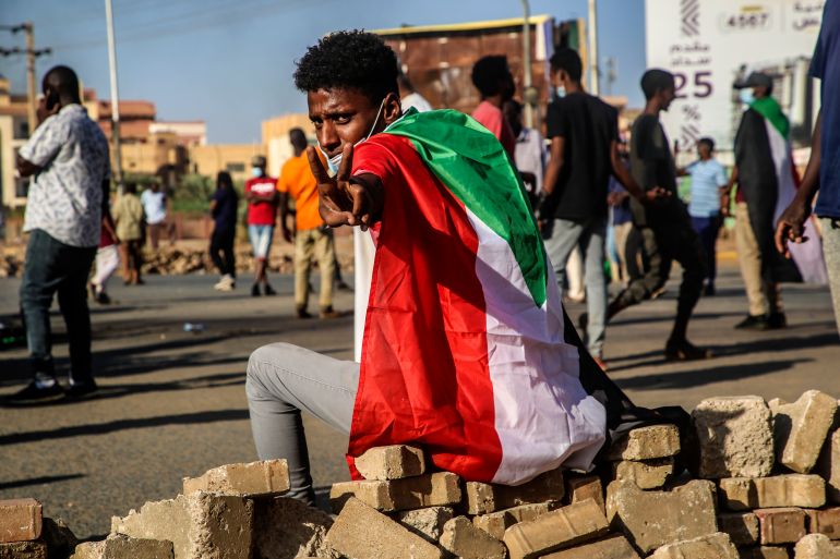 epa09580354 A Sudanese protester flashes the victory sign during a protest against the military coup in Khartoum, Sudan, 13 November 2021. According to medics, three anti-coup protesters were killed during protests in which security forces reportedly used tear gas to disperse the demonstrators gathering two days after the formation of a new Sovereign Council to rule the country. Sudan's military seized power on 25 October and arrested the Prime Minister and other senior ministers and civilian members of the Transitional Sovereignty Council during early morning raids. EPA-EFE/STRINGER