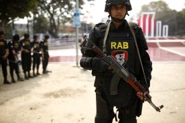 A member of RAB posing with a gun