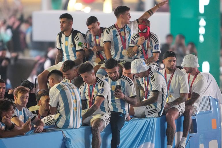 The Argentinian bus riding an open top bus celebrates on Lusail Boulevard in Qatar.