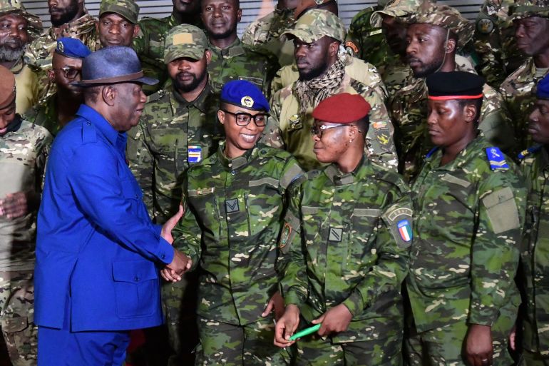 Ivorian President Alassane Ouattara speaks with some of the 46 Ivorian soldiers who were arrested in Mali in July.