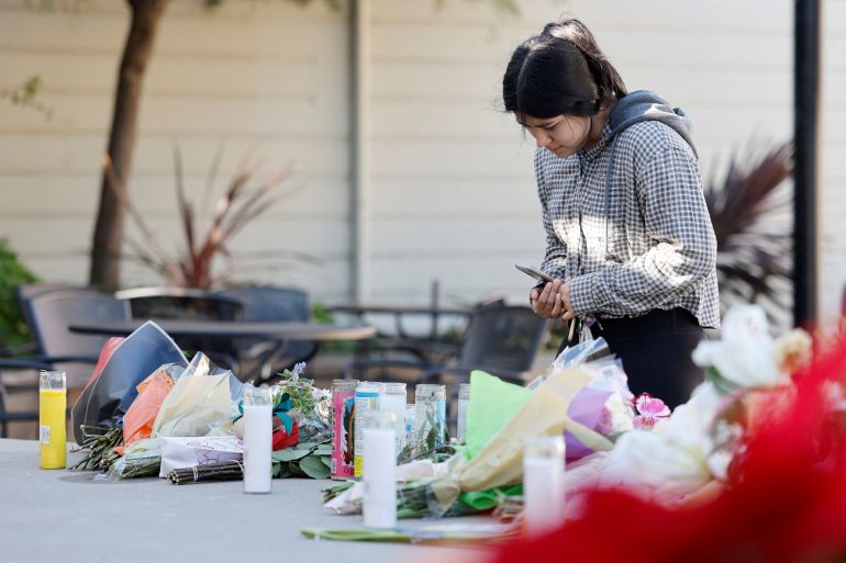 Half Moon Bay resident Susana Gutierrez visits a memorial for shooting victims at Mac Dutra Park in Half Moon Bay, California.